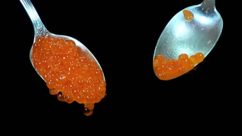 Two spoons with red caviar on a black Stock Footage 140472535