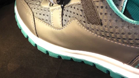 Two sport shoes on the rotating platform and circling around Stock Footage 111274115