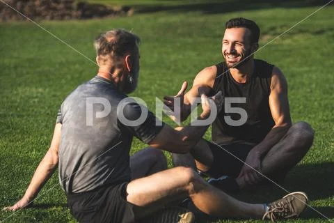 The two sportsmen handshaking on the grass Stock Photos