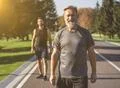 The two sportsmen standing on the road in the park on the sunny background Photo