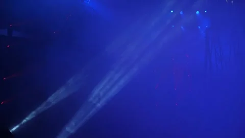 Two spotlights shine in the dark with smoke at a concert or circus performance. Stock Footage 312434265