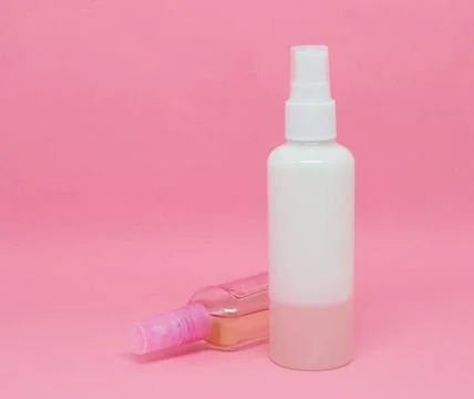 Two spray bottles on a pink background Stock Photos