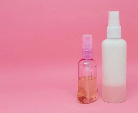 Two spray bottles on a pink background Stock Photos