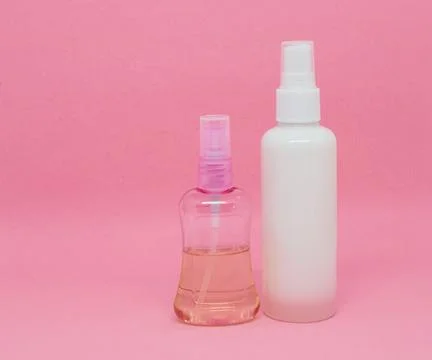Two spray bottles on a pink background Stock Photos