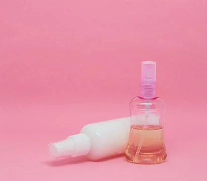 Two spray bottles on a pink background Stock Photos
