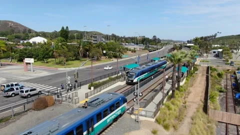 Two Sprinter Trains Meeting at Palomar College Station Aerial Stock Footage 334632398