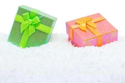 Two square gift boxes in snow Stock Photos