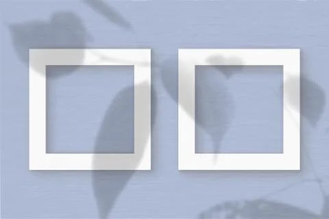 Two square sheet of white textured paper on the blue wall background. Mockup  Illustrazione stock