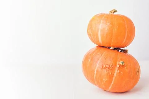 Two stacked mini pumpkins on white background. Stock-Fotos