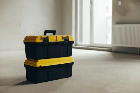 Two Stacked Tool Cases On Concrete Floor In Empty Room. Construction Equipment Stock Photos