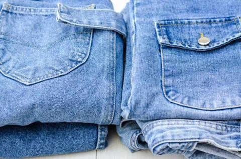 Two stacks of denim items next to each other. Close up of things. Stock Photos