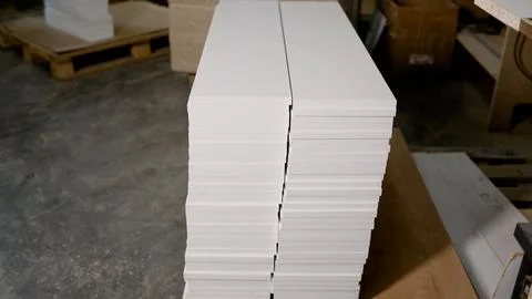 Two stacks of white laminated mdf boards for cabinets in furniture workshop Stock Photos