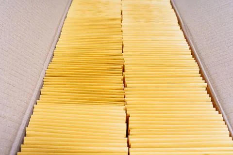 Two Stacks of Yellow Mailing Envelopes in a Shipping Box 스톡 사진