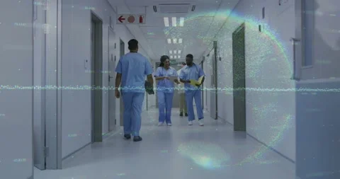 Two staff entering hall, walking, consulting clipboard, yellow folder for Stock Footage 334312198