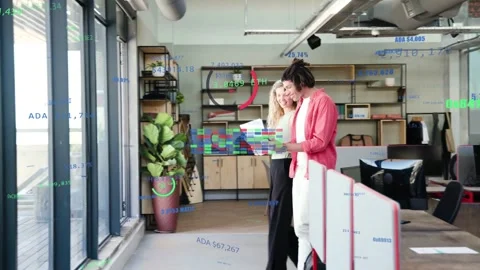 Two staff walking through business office angling tablet and reviewing data Stock Footage 331024983
