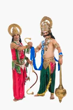 Two stage artists dressed-up as Rama and Ravana and shaking hands Stock Photos