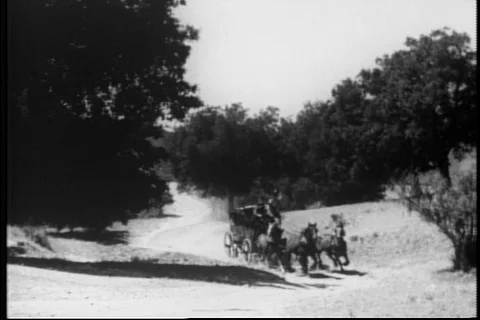 Two stage coaches racing through the country side, 1930s Stock Footage 90727799