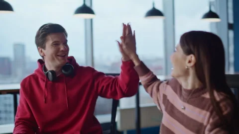 Two startupers giving five working on creative project at office closeup. Stock Footage 340078829