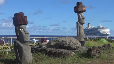 Two statues from Easter Island and a cruise ship in the background Stock Footage 162813632