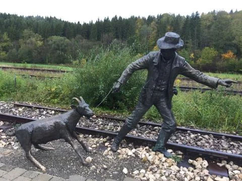 Two statues on a rail. Stock Photos