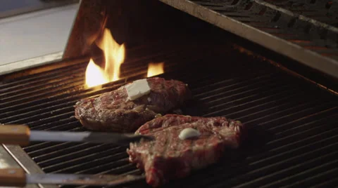 Two steaks grilling Video stock 36513887