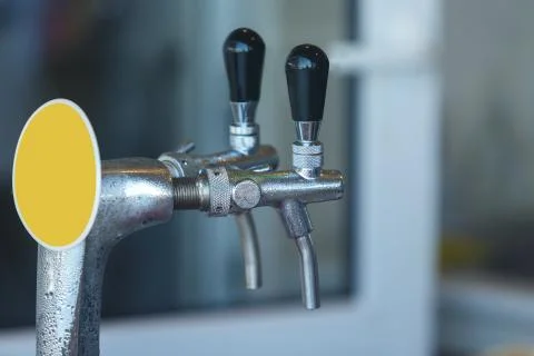 Two steaming taps for pouring beer. Close up Stock Photos