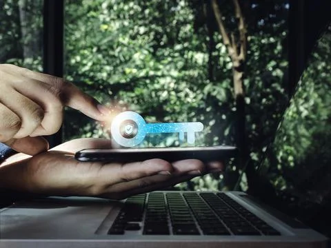 Two steps authentication concept. Virtual key icon on smartphone in hand with Stock Photos