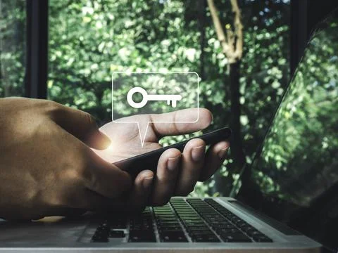 Two steps authentication concept. Virtual key icon on smartphone while using  Stock Photos