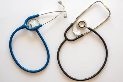 Two stethoscopes in rounded shape one blue and one black Stock Photos