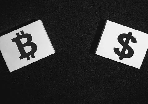 Two sticky notes on a black background with a bitcoin and a dollar on it Stock Photos