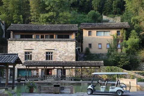 Two stone brick buildings with gable roofs and windows on one side have bee.. Stock Photos