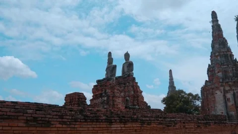 Two stone statues of Buddhas sit on red brick pedestal in the ruins in Ayutthaya Stock Footage 308877077