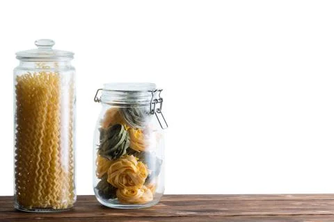 Two storage jars filled with fresh dried pastas Stock Photos