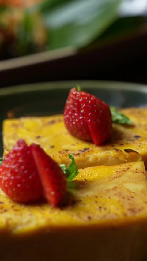 Two strawberries and a slice of yellow cake for food-themed videos Stock Footage 310578450