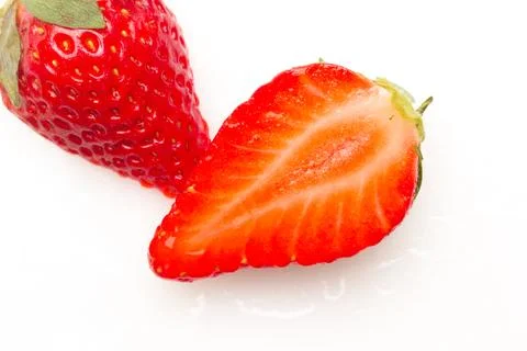 Two strawberries close up on white background Stock Photos