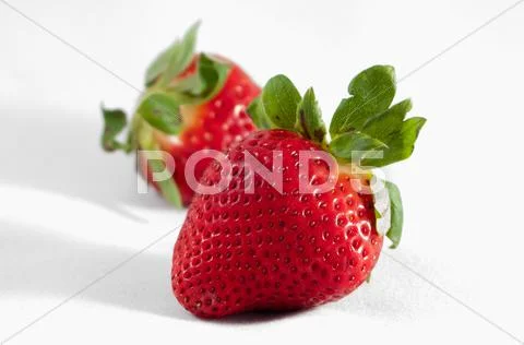 Two strawberries isolated on white background Stock Photos