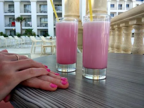 Two strawberry milkshakes with straws at a cafe Stock Photos