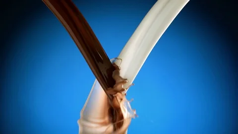 Two stream of milk and chocolate meet Stockbeeldmateriaal 81805600