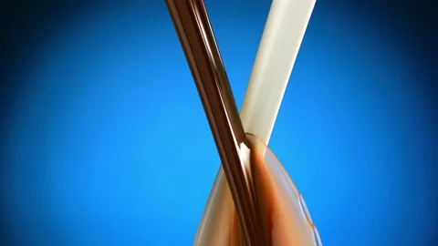 Two stream of milk and chocolate meet Stock-Footage 81805618
