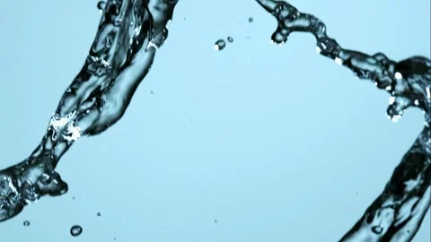 Two streams of water cross and splash in mid air Video stock 326625260