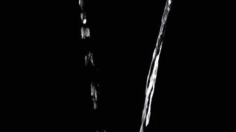 Two Streams of Water with Drops Pour into Empty Space on Black Background Stock Footage 312014242