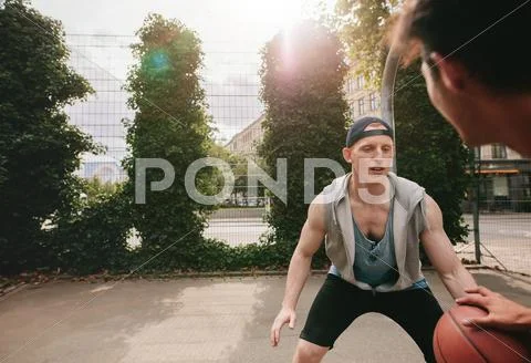 Two streetball players on the basketball court Stock Photos