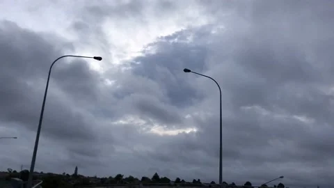 Two streetlights under dark rain clouds Video stock 184328662