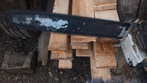 Two-Stroke Chainsaw Cutting Wood with Intermittent Engine Revs, Chain Rattle, an Stock Footage 338170320