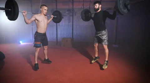 Two strong man doing weightlifting training together at the gym Stock Footage 68655994