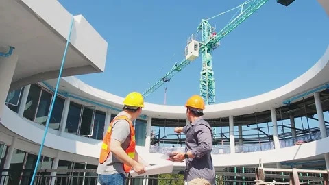 Two structural engineer and architect standing in front of mechanical crane. Stock Footage 215975501