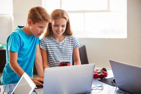 Two Students In After School Computer Coding Class Learning To Program Robot Stock Photos