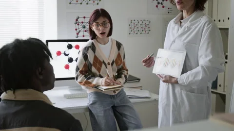 Two Students Asking Their Science Teacher Questions During Biology Class Stock Footage 312327199