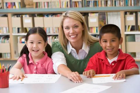 Two students in class with teacher Stock Photos