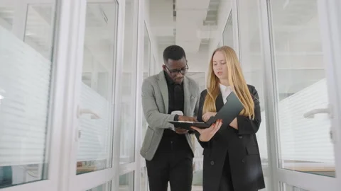 Two students diverse race and nationality work and study together, discuss paper Video stock 187498895